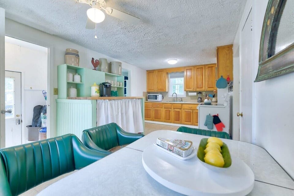 [Dinning, Downstairs] Step into an intimate dining setting with vintage chairs, inviting conversation and culinary delights for four.