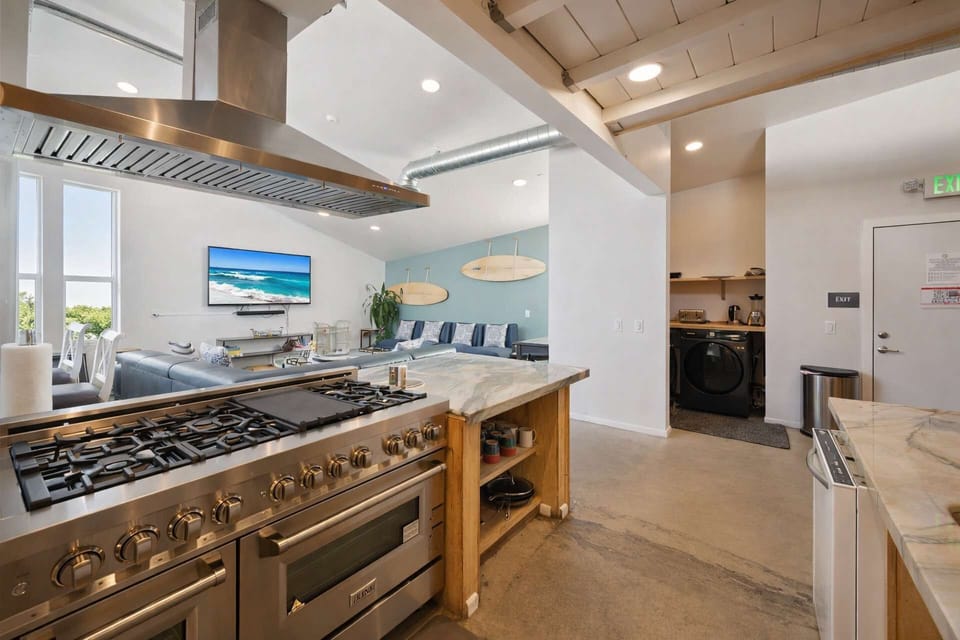 Surf Loft–Style Chef Kitchen with a Professional Gas Range, Custom Wood Finishes, and an Open Layout — Perfect for UP TO 25 GUEST EXPERIENCE, Cooking, Hosting, and Group Meals