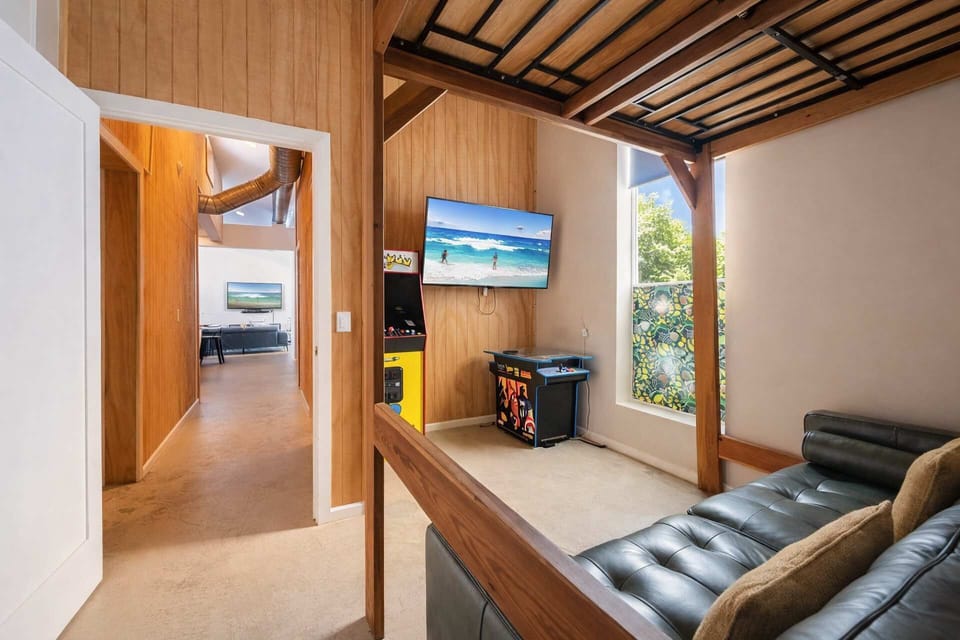 Spacious Bunk Room with 2 Queen Beds and 1 Single Bed, Featuring a Cozy Gym Corner — Perfect for Families, and a Comfortable Resort-Style Stay