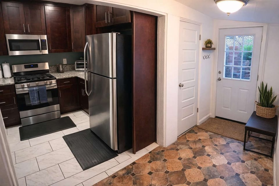 Bright Entryway & Modern Kitchen w/ Stainless Steel Appliances, Granite Counters & Clean Tile Floors | Functional Layout w/ Easy Access & Stylish, Welcoming Feel 
