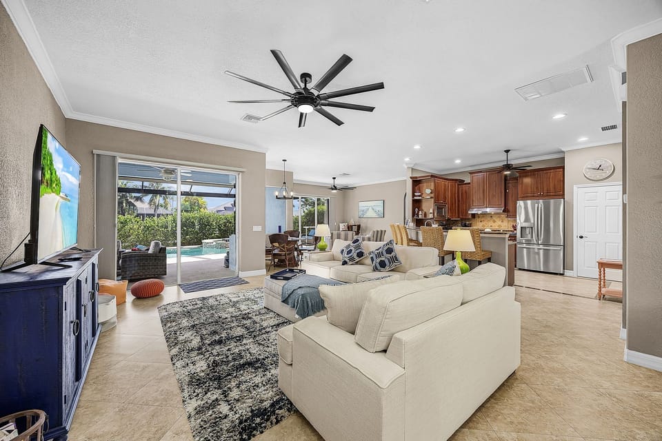 The living room has comfortable seating & a flat-screen TV
