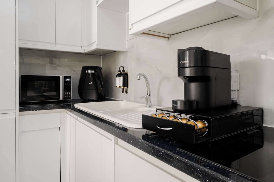 Full Kitchen | Our fully equipped kitchen boasts a range of modern conveniences, including a washing machine, dryer, microwave, espresso machine, and a fresh water dispenser, ensuring optimal convenience for all your culinary needs.