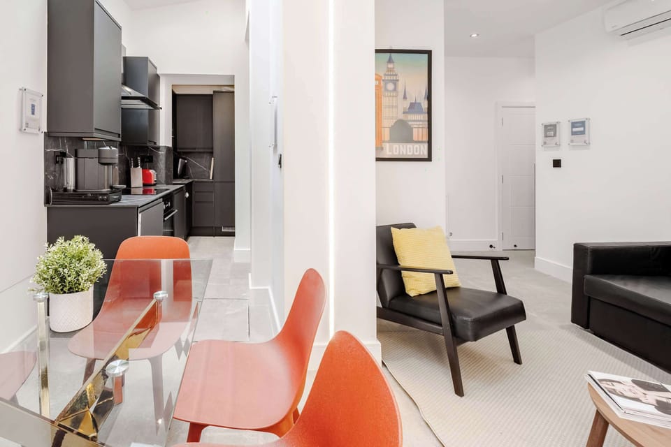 Living Room | Experience comfort in our beautifully designed living room, featuring a state-of-the-art 65-inch smart TV and premium air conditioning to ensure a cool and relaxing stay.