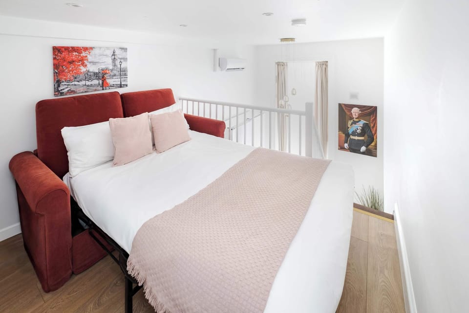 Bedroom 2 | The second bedroom offers versatility with a mezzanine layout, effectively combining two bedrooms into one. Enjoy a king-size bed on the lower level and a queen sofa bed on the upper mezzanine, providing ample sleeping space.