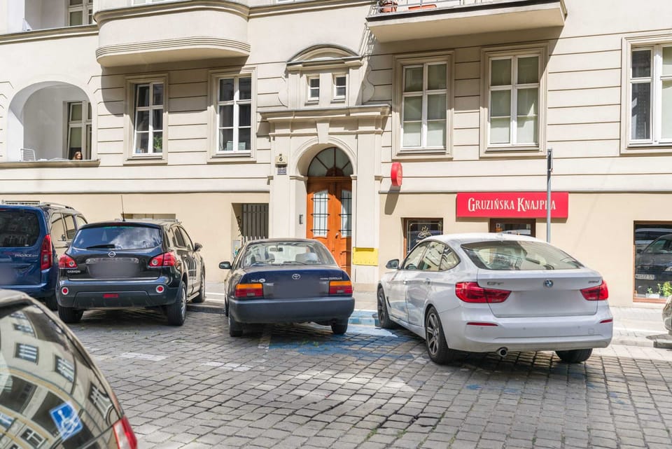 The exterior of the building, surrounded by historic architecture and a vibrant urban setting.
