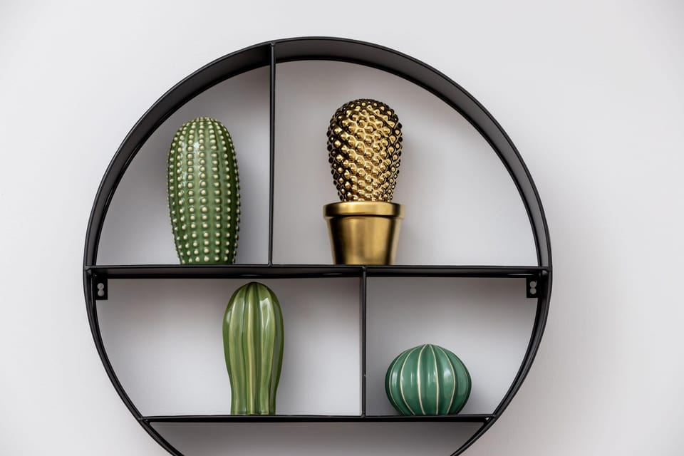A floating shelf adorned with a few decorative items and a small potted plant. Its clean, streamlined look adds a modern accent.