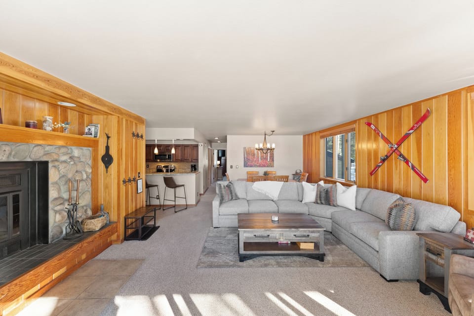 Ample seating surrounds a cozy wood-burning fireplace.