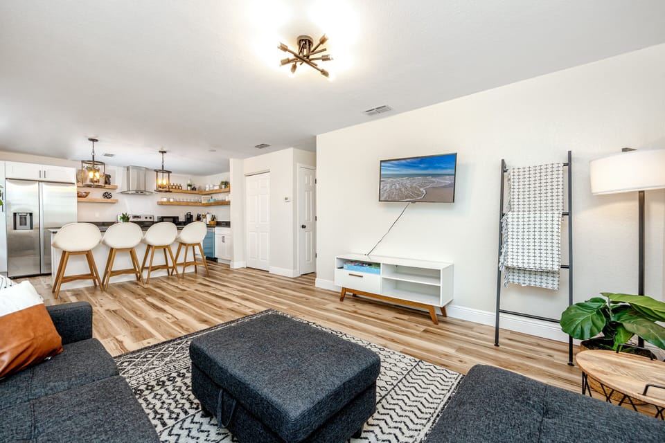 Cozy living room with couch, Netflix TV, fast WiFi, and all-night comfort.