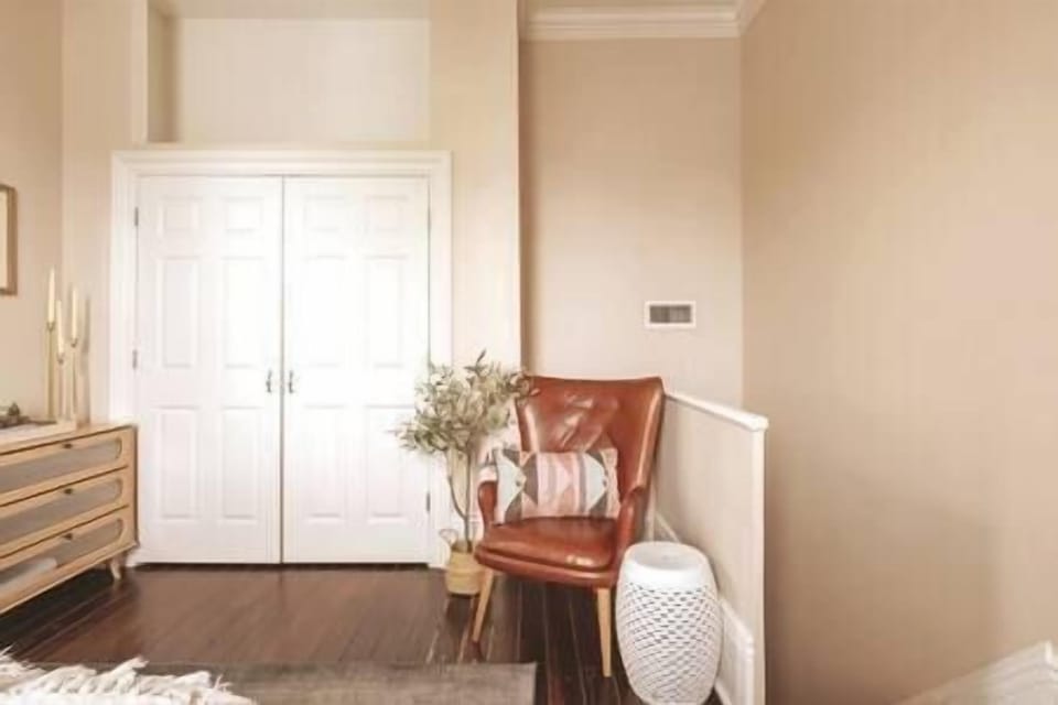 Seating area with reading nook in upstairs bedroom with ample closet and dresser space