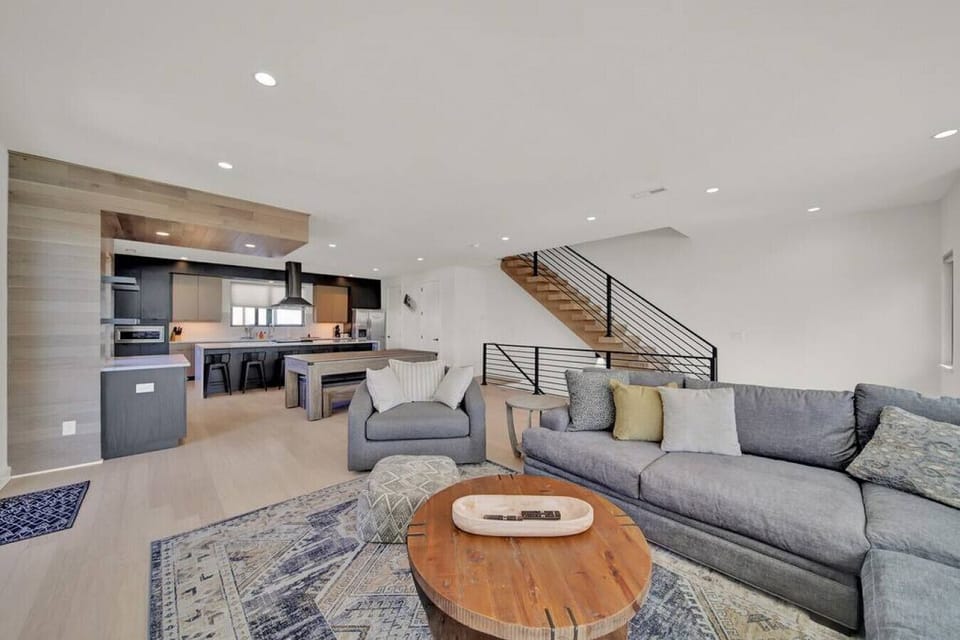 The kitchen area is fully lit up by the windows, casting a glow across the entire open plan concept which seamlessly blends the pool table, living room area and glorious kitchen.