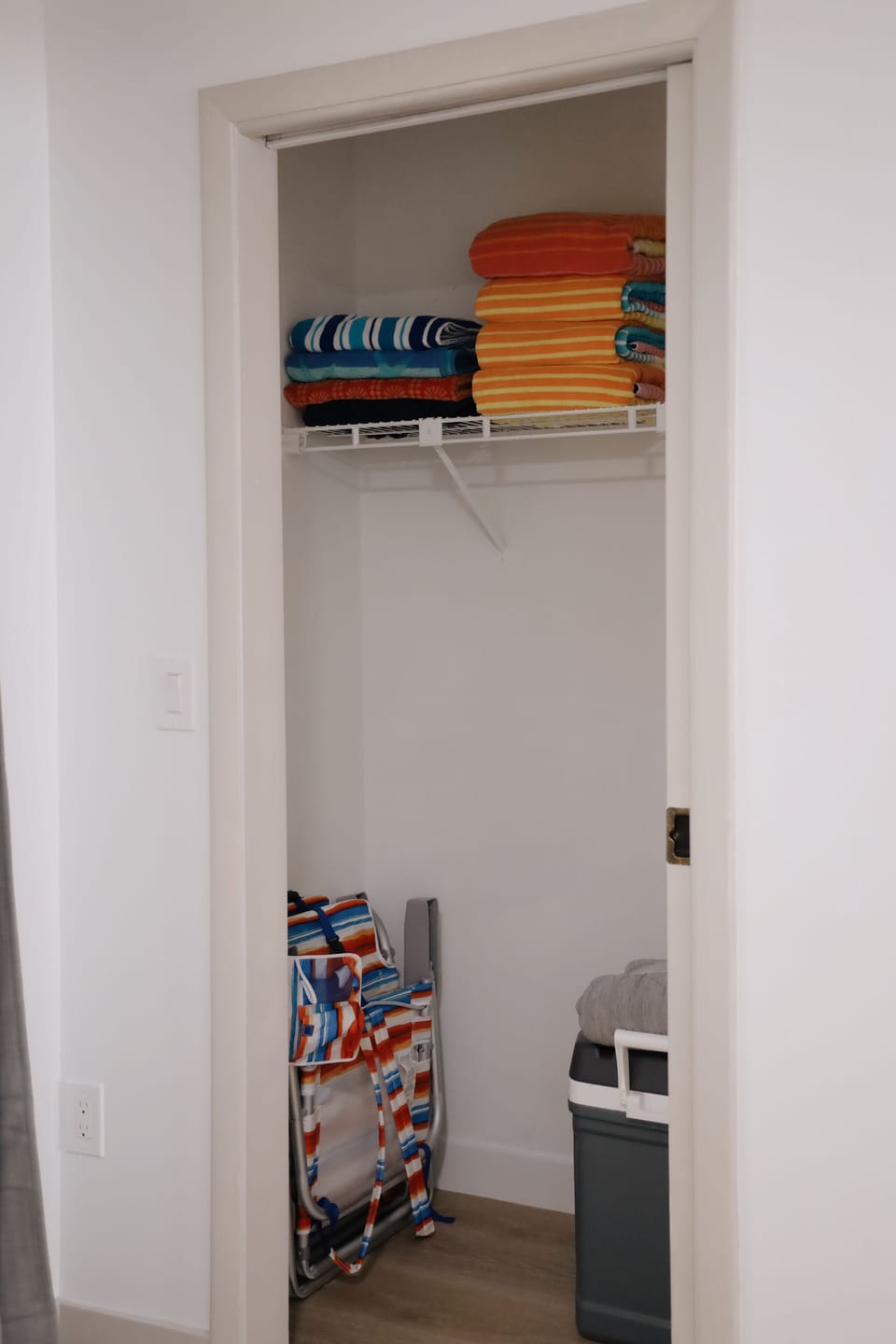 Beach chairs, cooler, cart, baby toys and towels