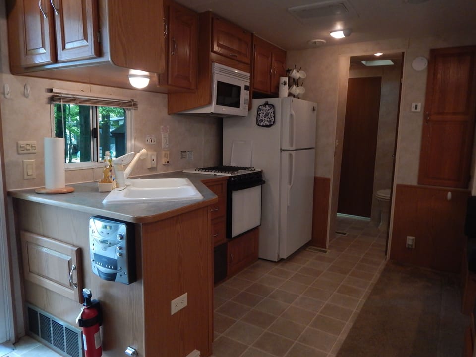 kitchen with stove, oven, microwave, and full size refrigerator
