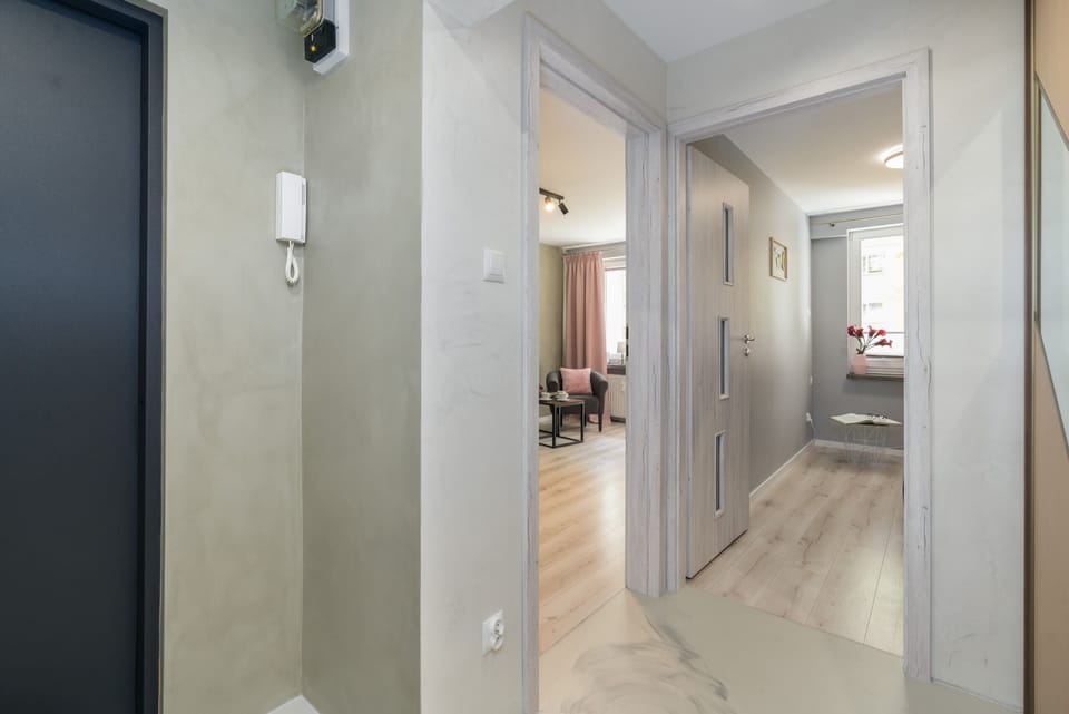 A hallway with a large mirror wardrobe, leading to different parts of the apartment.
