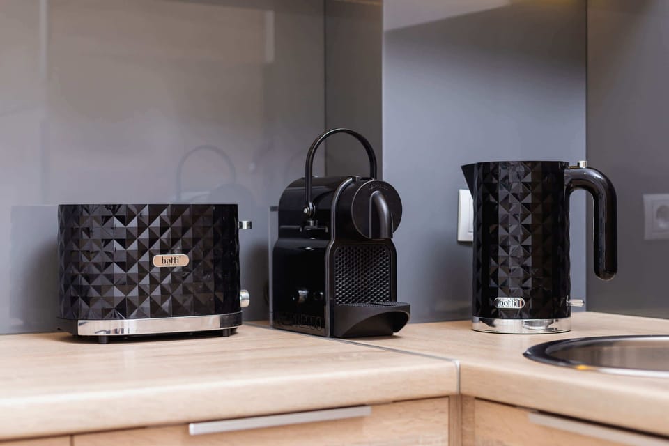 The sleek design of the kitchenette blending seamlessly with the living area.
