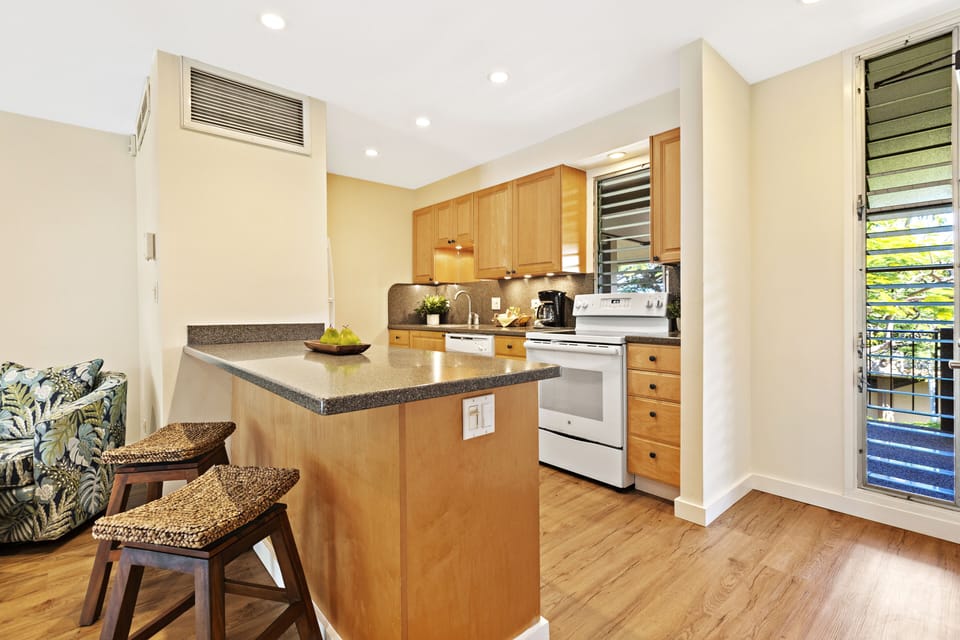 Kitchen Angle – Entry View - A bright, inviting kitchen with wood cabinetry and clean countertops.