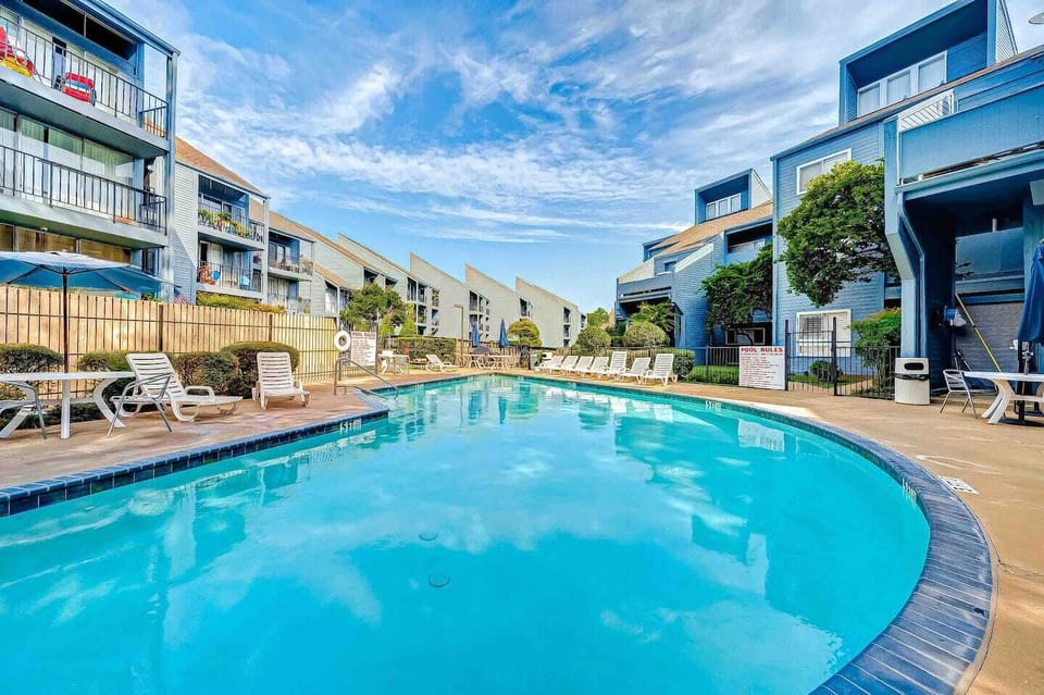 Complex pool. Loungers, tables, and umbrellas provided by complex.