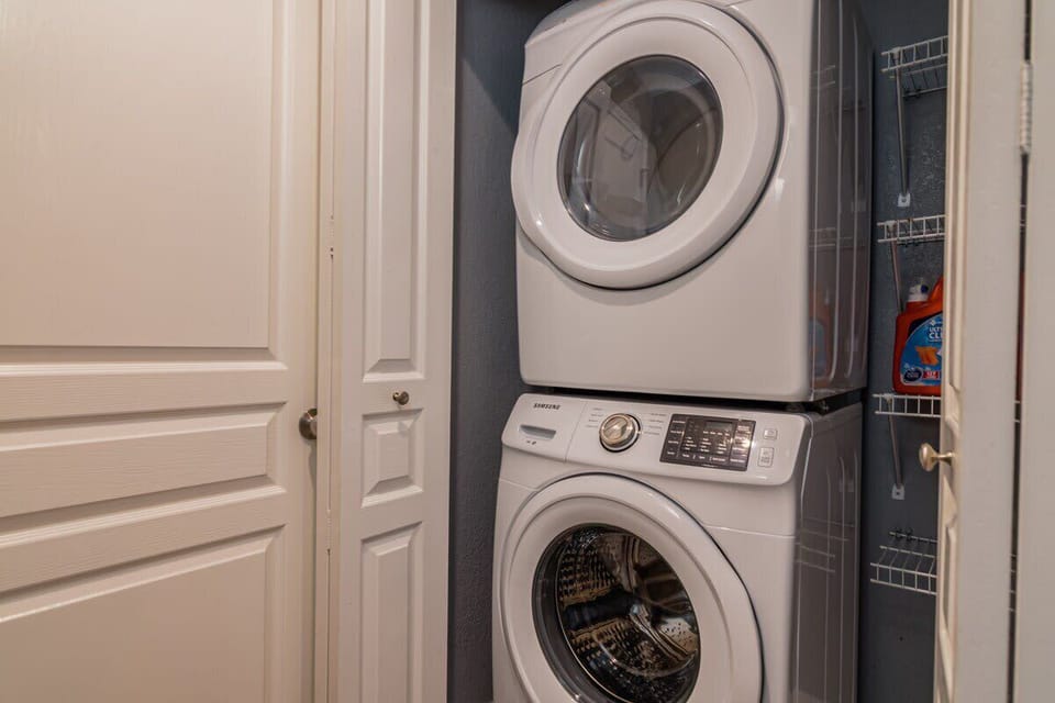 There is a full sized stackable washer and dryer stocked with detergent for your travel laundry needs.