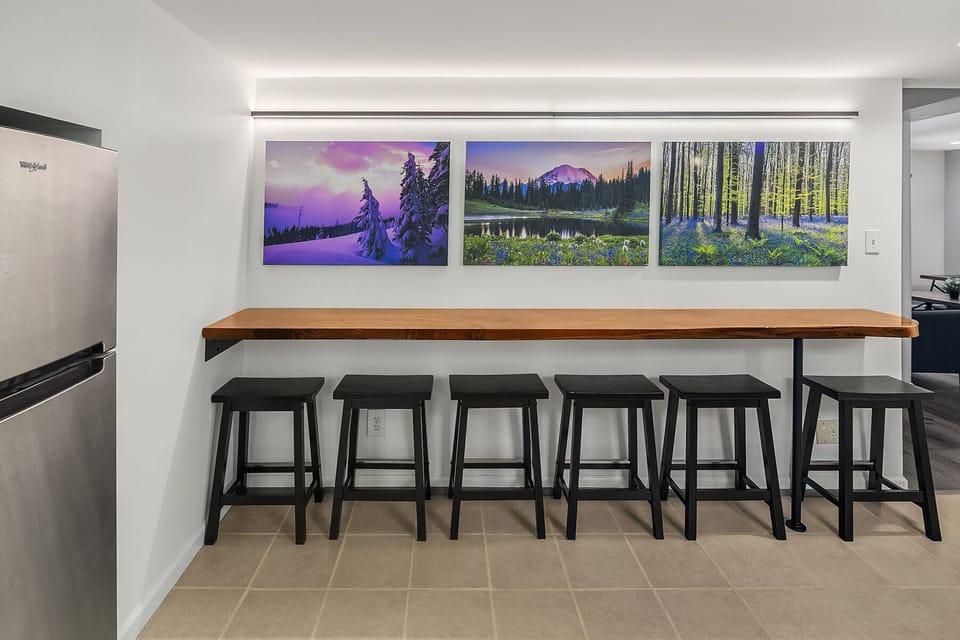 The kitchen features a unique 10 foot walnut live-edge bar which seats 6 people.