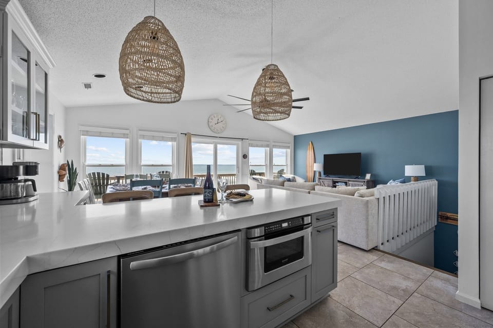 The kitchen is open to the dining area, which seats 8 + 3 bar stools at the adjacent kitchen island.