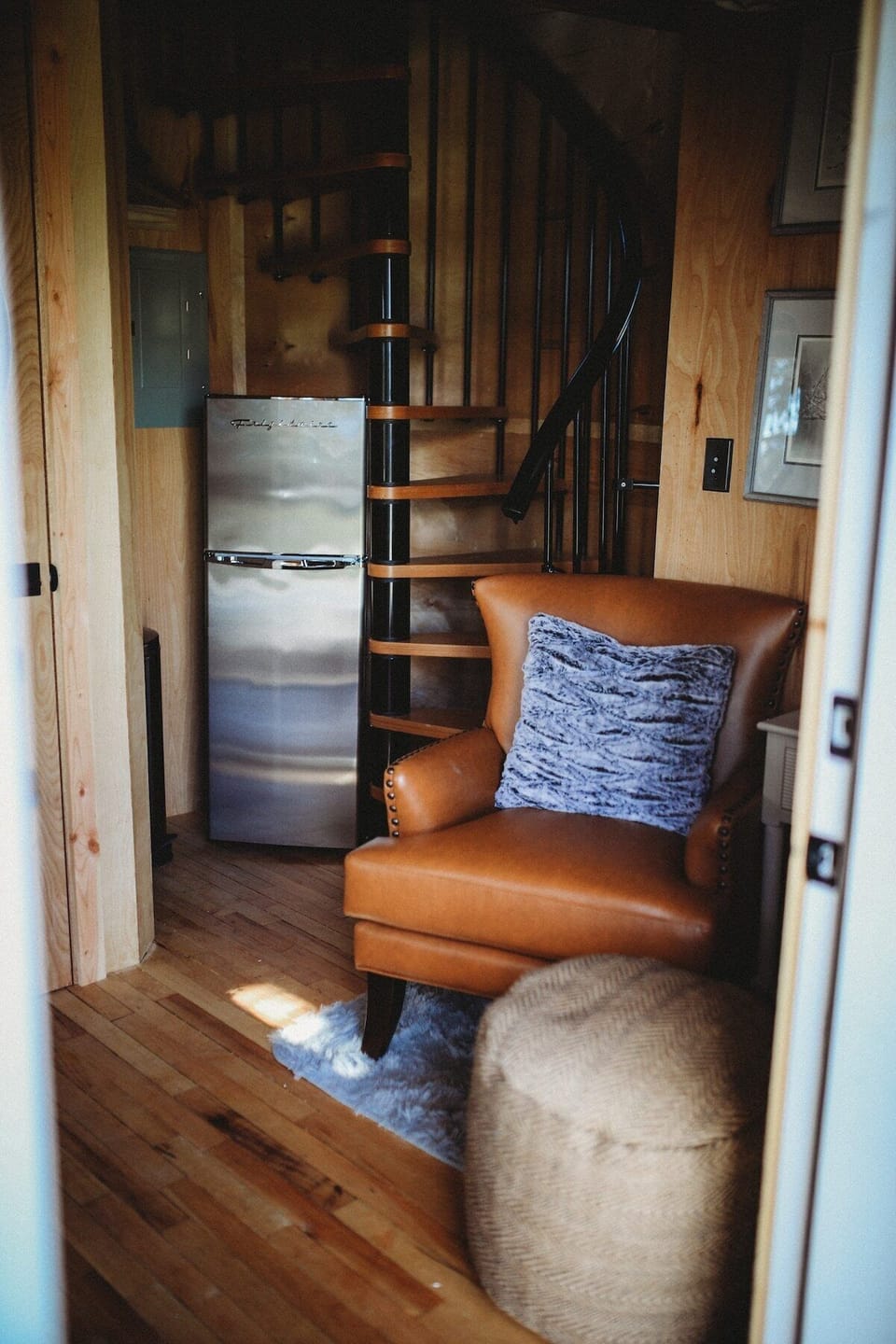 Relax in your treehouse retreat, complete with a charming spiral staircase and stylish seating for ultimate relaxation.