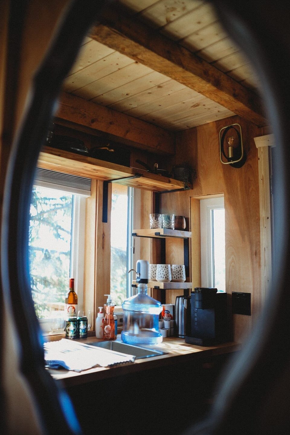 A beautifully organized treehouse kitchen with all the essentials, perfect for cooking up your favorite meals with natural light and modern appliances.