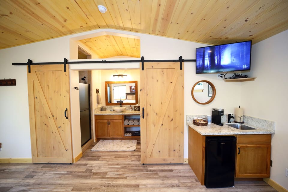 Private bathroom area with barn doors.