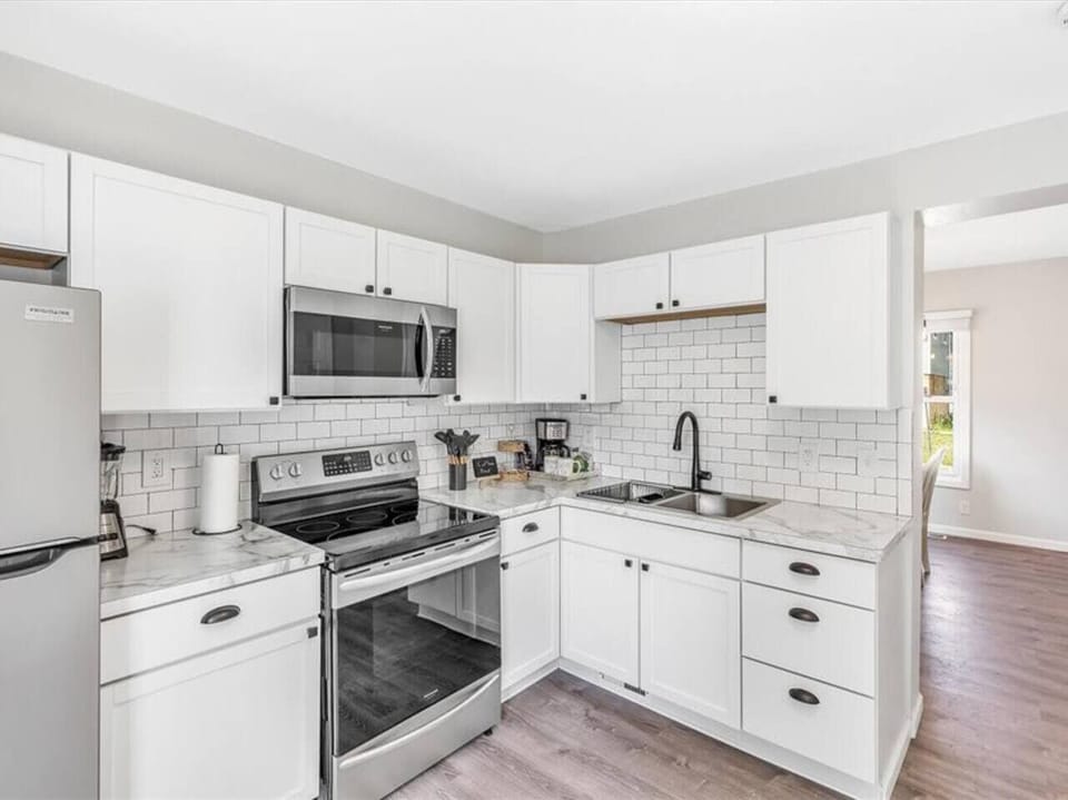 You’ll find double sinks, a refrigerator, electric oven/range, and microwave.