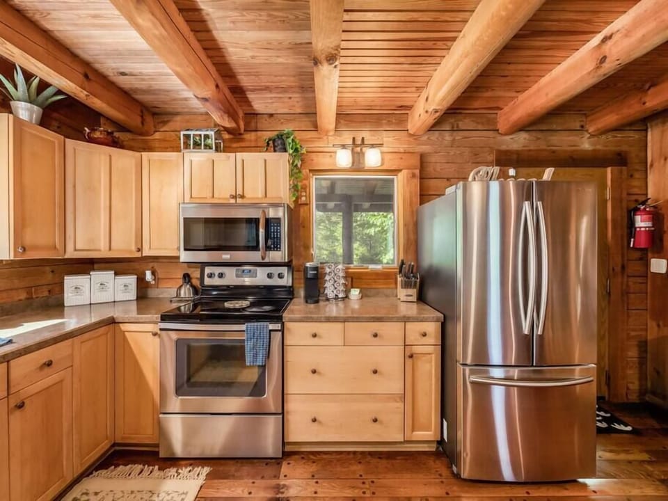 Kitchen in the main cabin with all new stainless steel appliances and coffee bar