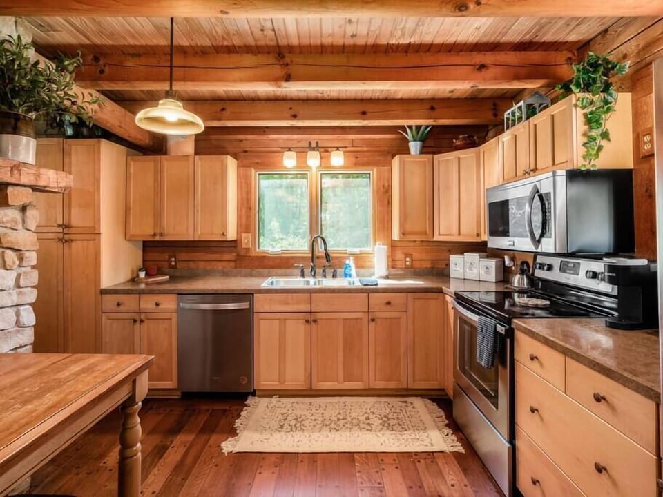 Rustic kitchen with wooden cabinets for a delightful culinary experience.