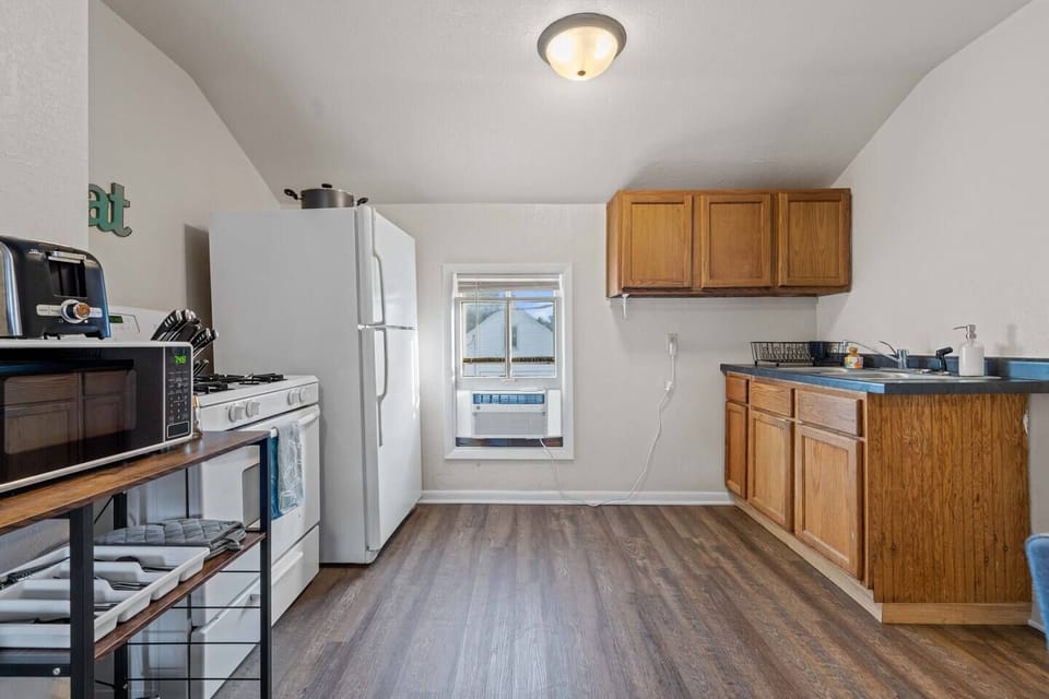 View of the kitchen from entryway. Kitchen includes AC unit and view of the parking area.