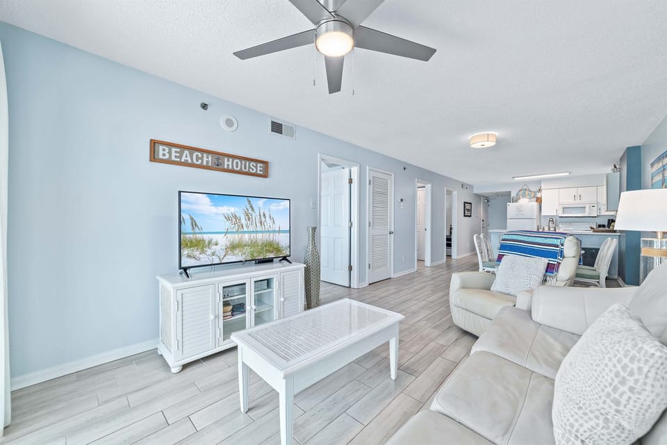 This well-appointed living space offers a convertible sofa bed, a coffee table, and a dining area with seating for six, creating a welcoming atmosphere.