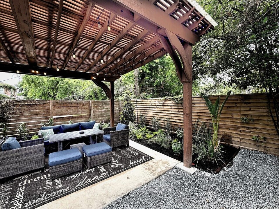 Covered lounge and dining under the pergola — the whole family eats together outside.