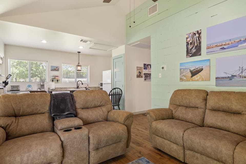 Living room complete with electric reclining lovesest and couch.
