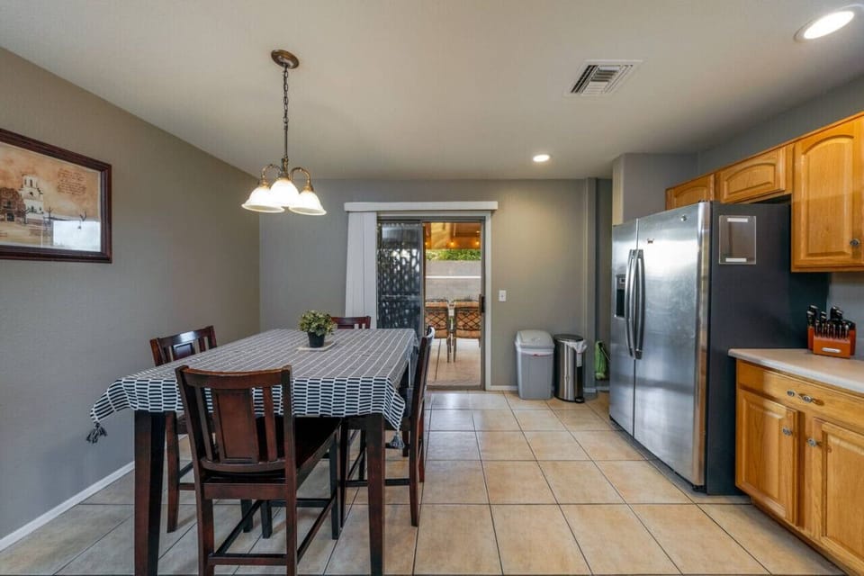 Sliding glass door leads from kitchen to outdoor covered patio (Please see kitchen photos with updated dining table)
