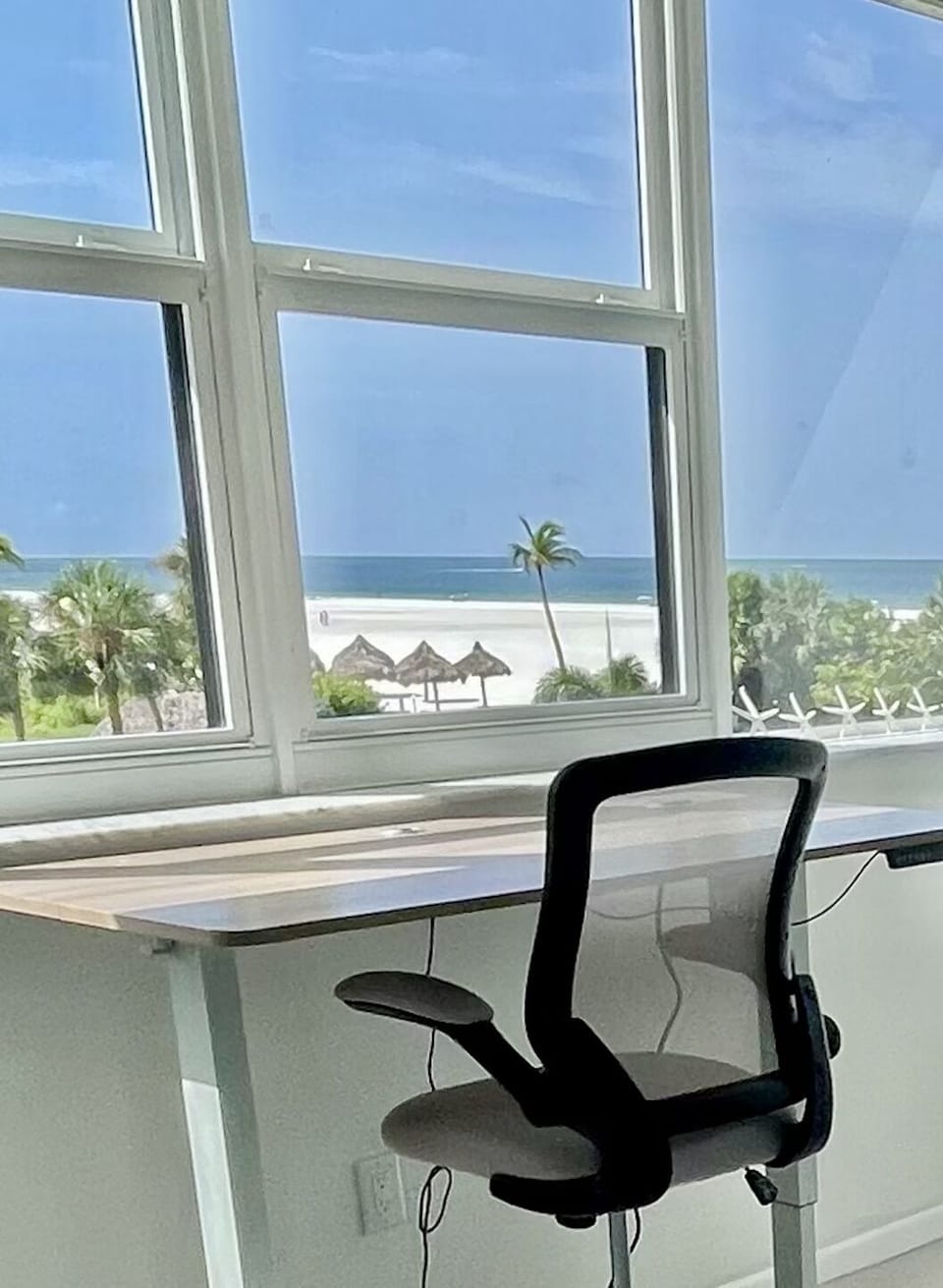 Guest bedroom desk overlooking the pool area, beach and ocean