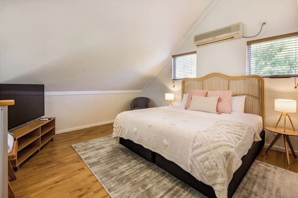 Wake refreshed in the primary bedroom, where a king bed offers a restful night's sleep beneath soft coastal-inspired styling.

