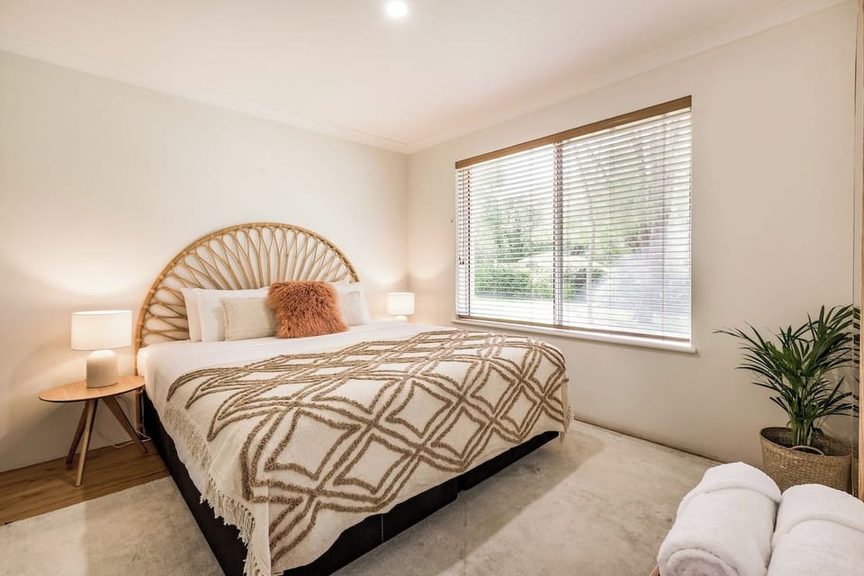 The second bedroom features a king bed dressed in quality bed linen, creating a peaceful retreat after a day exploring Dunsborough.
