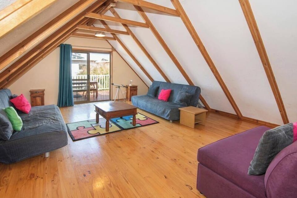 The upstairs loft features a cosy second lounge with two sofa beds, accommodating up to two guests.