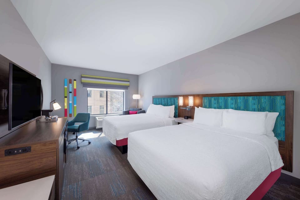 Hypo-allergenic bedding, desk, laptop workspace, blackout drapes