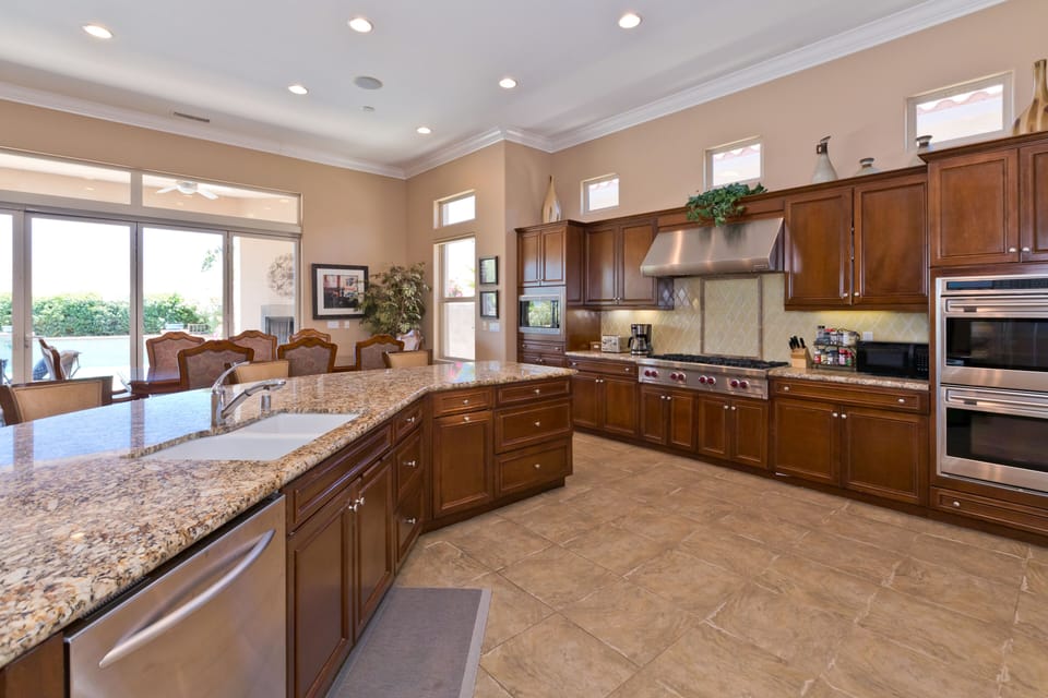 Gourmet chef's kitchen features granite counters, sub zero fridge, Wolf range