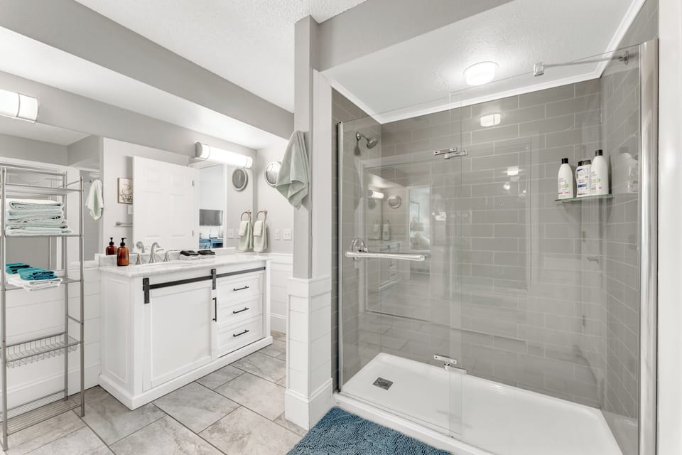 New and remodeled bathrooms with a walk in shower and a tub in the second.