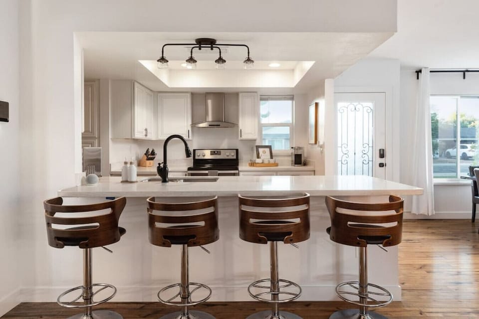 Bright kitchen with bar seating and everything you need to cook at home.