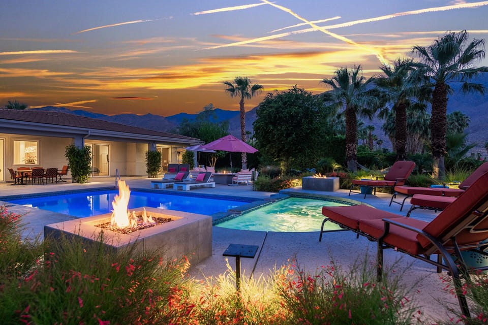 Large Spa Features Two Fire Pits and Flows Into Pool