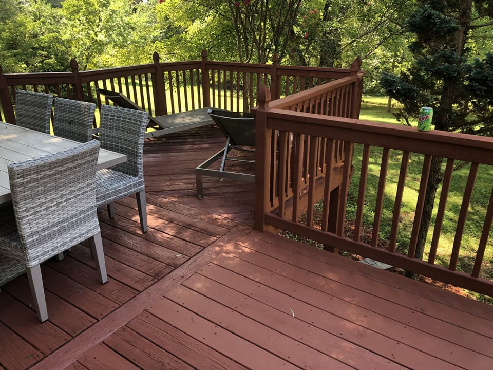 Deck overlooks backyard.