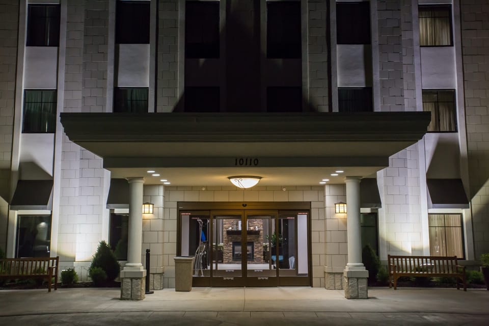 The welcoming entrance shines in the evening glow, inviting you to come inside.