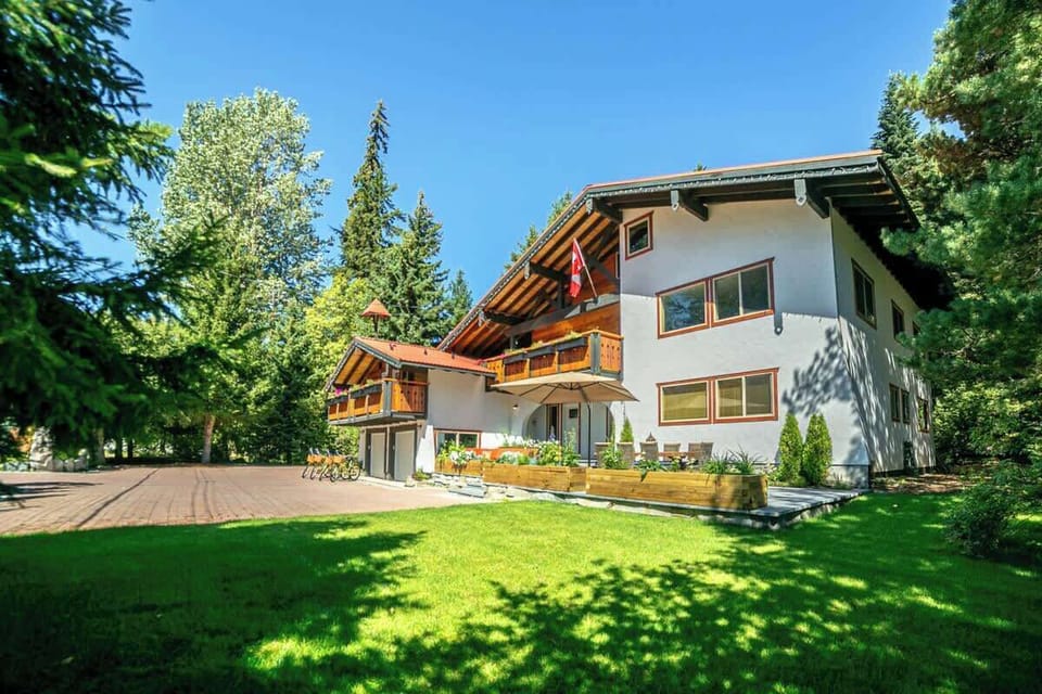 - Beautiful alpine-style home surrounded by tall trees and open greenery  
- Spacious yard with sunny balconies ideal for outdoor relaxation and views  
- Perfect year-round retreat offering comfort charm and mountain serenity  
