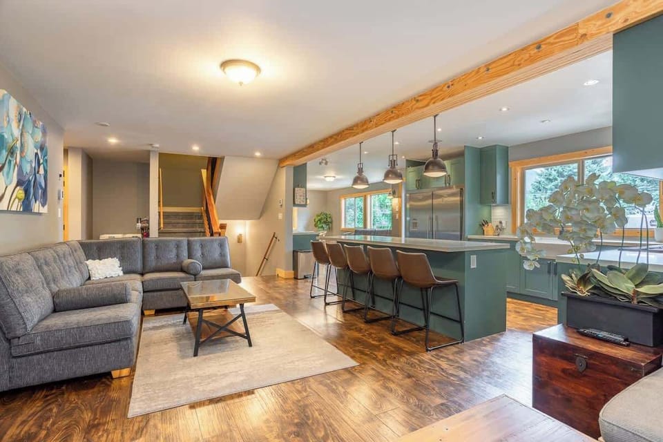 - Open living and kitchen area designed for warmth, comfort, and connection  
- Modern lighting, forest views, and rustic touches enhance the cozy vibe  
- Perfect space to cook, relax, and share memories in a stylish mountain home  
