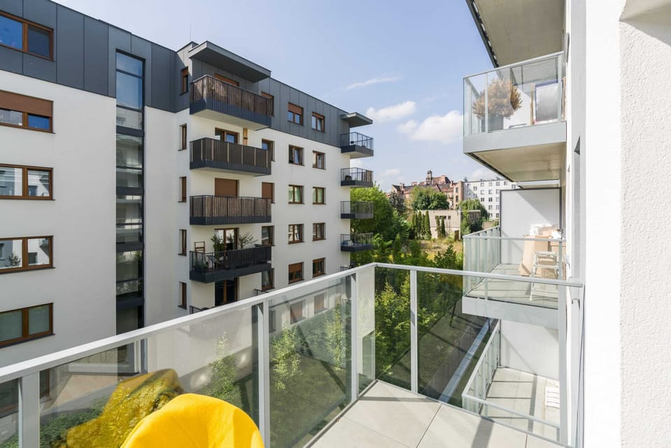 The furnished balcony offers a perfect spot for morning coffee with a view.