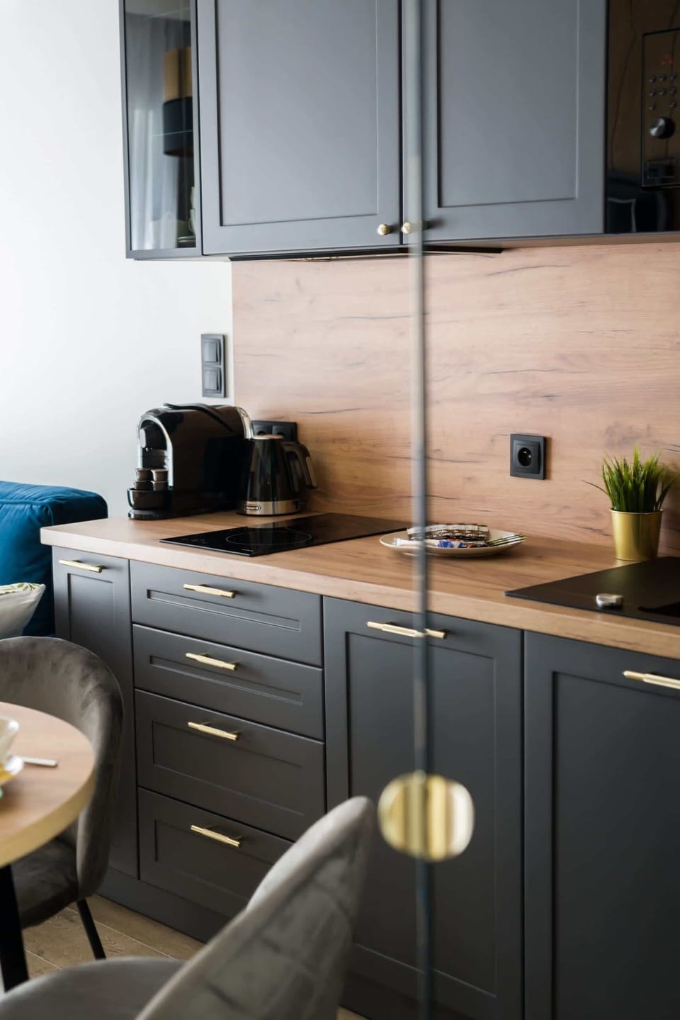 The sleek design of the kitchenette blending seamlessly with the living area.