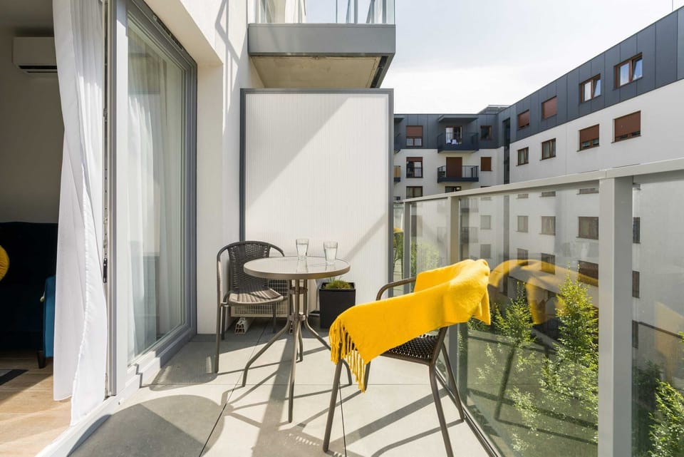 The balcony's stylish design complements the apartment's decor. 